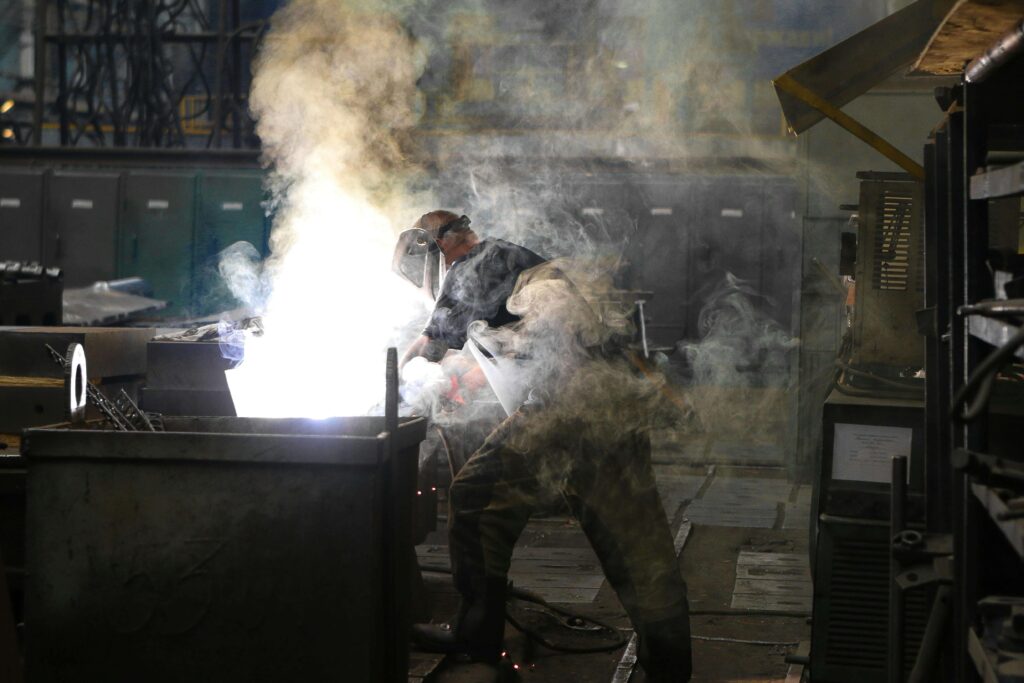 A machine shop worker performing tasks based on an andon board